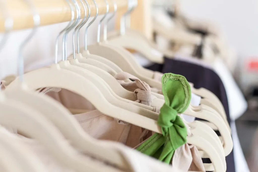 Light-coloured clothes on hangers